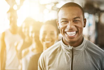 Foto op Canvas Fitness, black man and portrait with team, workout class and training in a health and wellness club. Lens flare, happy and smile with diversity and personal trainer with exercise, sports and group © Chanel Mentoor/peopleimages.com