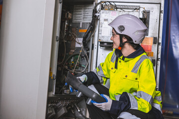 electrician woman worker. electricity engineer female working in high voltage circuit cabinet....