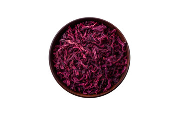 Dried beets in small slices in a wooden bowl on a black concrete background