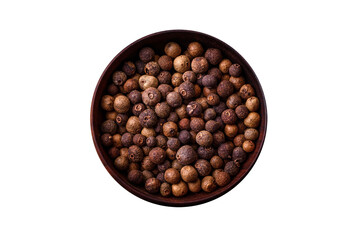 Spice allspice brown color not ground in a wooden saucer. Asian food