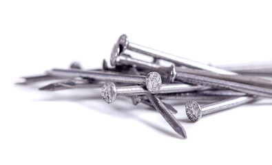 Pile of small grey metal nails isolated on white background. Close-up