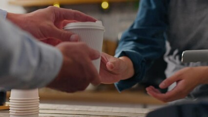 The client, the master barista, dispenses coffee in a modern coffee shop. Slow motion barista is in the workplace new ways of preparing drinks, waitress. Getting a takeaway drink in a paper cup