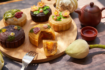 Mid Autumn Moon Cake on the wooden board under sunlight 