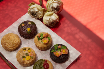 Mid-Autumn Festival food moon cake and tea on red background