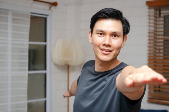 Portrait Of An Asian Man Exercising At Home. Sport Concept. Health Care.