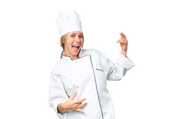 Young chef woman over isolated chroma key background making guitar gesture