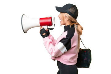 Pretty sport woman with sport bag over isolated chroma key background shouting through a megaphone