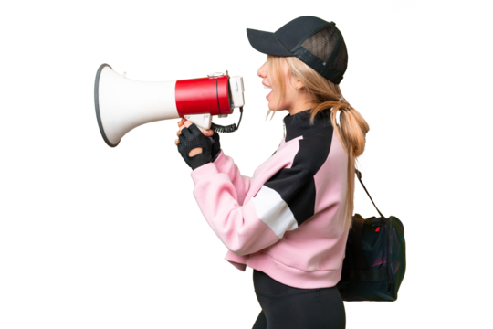 Pretty sport woman with sport bag over isolated chroma key background shouting through a megaphone