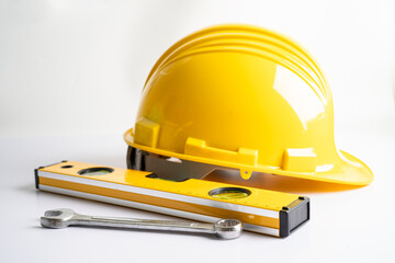 Architectural house plan project blueprint and yellow helmet with calculator, engineer construction tools.