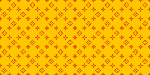 A pattern of orange four-pointed elements and a yellow background.