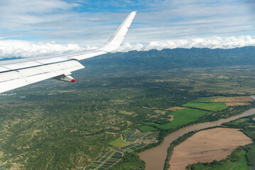 Aerial view of a river, mountain and crop fields in a Colombian landscape.