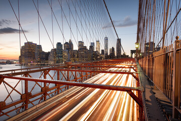 The view of the Financial District in New York City behind traffic on the Brooklyn Bridge