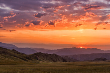 Dawn of the sun in the Dzungarian Alatau in the southeastern part of Kazakhstan