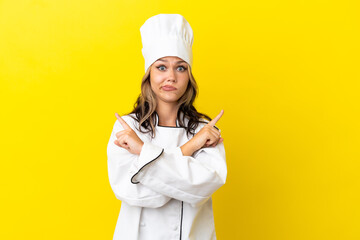 Young Russian chef girl isolated on yellow background pointing to the laterals having doubts