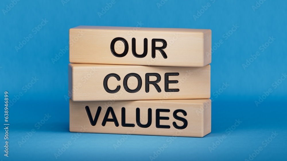 Poster our core values symbol. concept words 'our core values' on wooden blocks, businessman hand. business