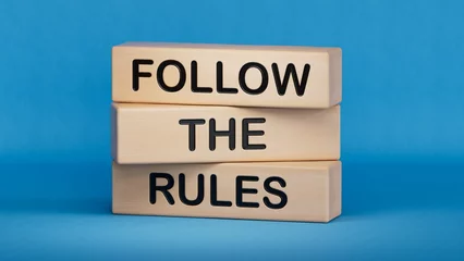 Fotobehang Follow the rules symbol. Concept words Follow the rules on wooden blocks. Business and follow the rules concept. Copy space.3D rendering on blue background.  © bo