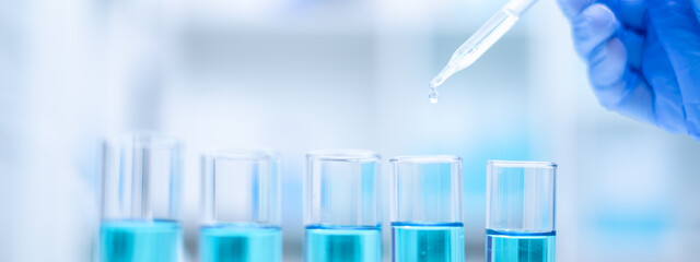 Close up scientist use dropper with blue liquid dripping with precision, substance holds the key to discovery in biology, medicine, and biotechnology, research and analysis through experiment analysis