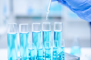 Close up scientist use dropper with blue liquid dripping with precision, substance holds the key to discovery in biology, medicine, and biotechnology, research and analysis through experiment analysis