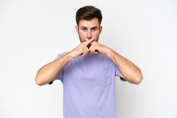 Young caucasian man isolated on white background showing a sign of silence gesture