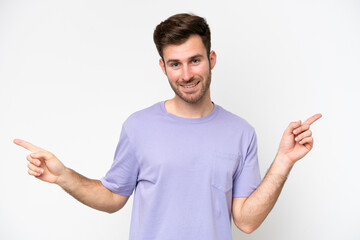 Young caucasian man isolated on white background pointing finger to the laterals and happy
