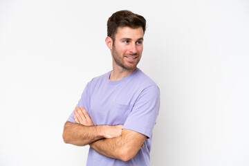 Obraz premium Young caucasian man isolated on white background with arms crossed and happy