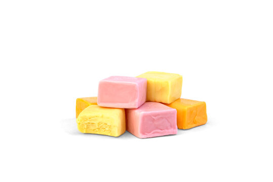 Pile of color square chewable candies isolated on white background.