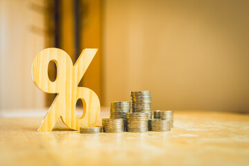 Percentage model with coins stack. Concepts of the banking system, rising interest rates, inflation, deflation, and savings.	