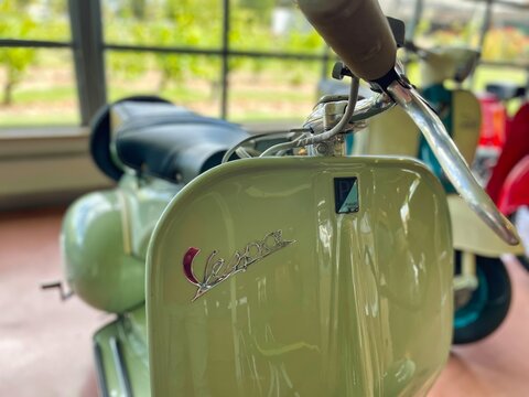 montevideo, uruguay - October 31 2022: vintage vespa italian scooter on display in yellow green colors
