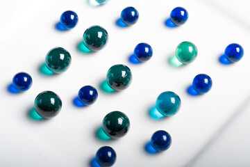 Colorful Marbles on a White Plate