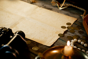 Treasure island concept on a wooden table background. Sheet of paper for text