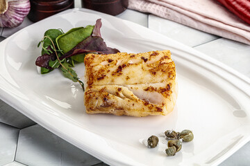 Roasted cod fish steak with salad