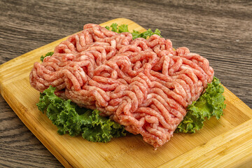 Raw pork minced meat over board