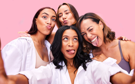 Girl group, studio selfie and funny face with solidarity, diversity and happy for blog by pink background. Women friends, comic memory and smile for photography, memory and post on social network