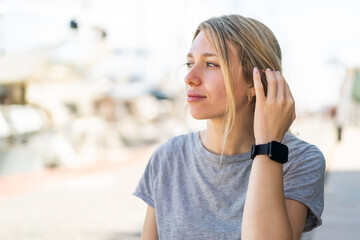 Fototapeta premium Young blonde woman at outdoors with sport watch