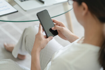Woman hand using smartphone for checking social media or  woman reading ebook on screen.