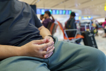 Obraz premium Man waiting for flight in airport departure area at airport waiting the flight