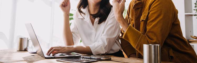 Obraz premium Entrepreneur Asian businessman and businesswoman discussing new business project in tablet in modern Meeting In Modern Office, Asian business casual concept.