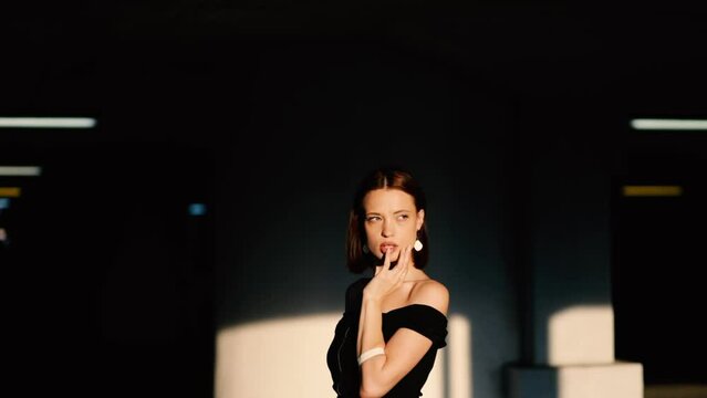 sexy woman model in black dress posing elegantly and sensually. The most beautiful woman with a reference appearance.