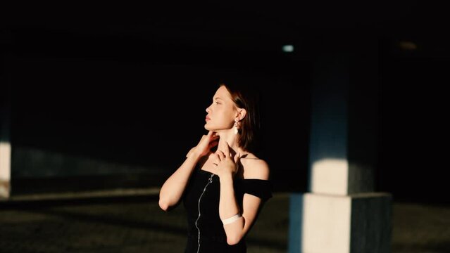 sexy woman model in black dress posing elegantly and sensually. The most beautiful woman with a reference appearance.