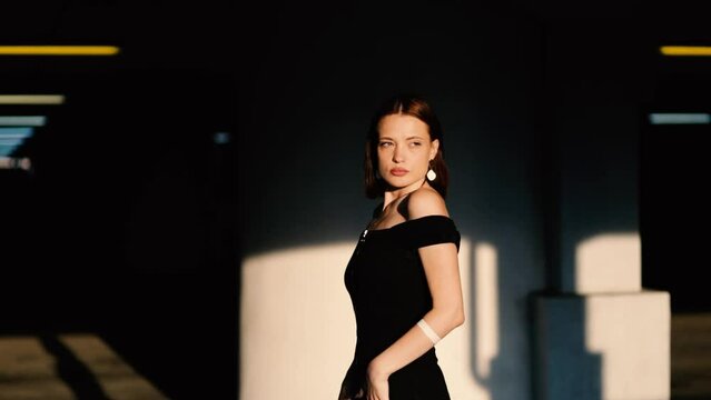 sexy woman model in black dress posing elegantly and sensually. The most beautiful woman with a reference appearance.