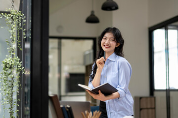 Businesswoman busy thinking and writing a new project.