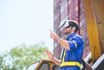 Engineer or technician worker wear PPE reflection cloth and virtual reality headset or VR glasses, acts like searching data in cloud database. Technology for helping logistic delivery management.