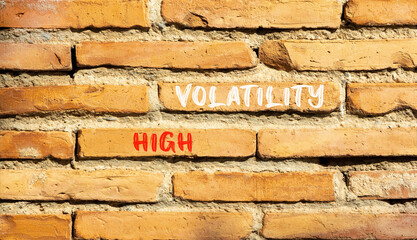 High volatility symbol. Concept words High volatility on beautiful brick wall. Beautiful red brown brick wall background. Business high volatility concept. Copy space.