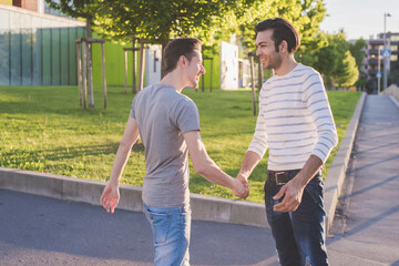 Two young multiethnic men outdoors celebrating success