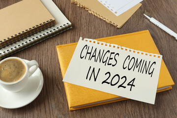 beautiful yellow notepad on the work table. text on the page Changes coming in 2024