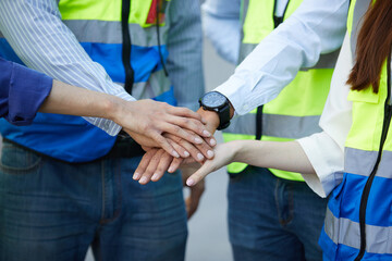 group of workers join hands together for success work or project