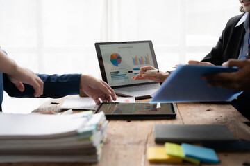 Young colleagues having great business conversations in a modern coworking office. Teamwork concept. Horizontal blurry background. Fireworks.