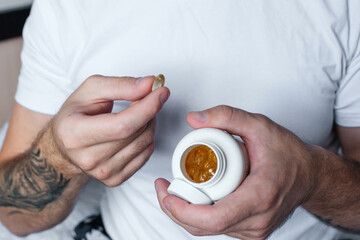 Man holding omega 3 vitamins in his hands