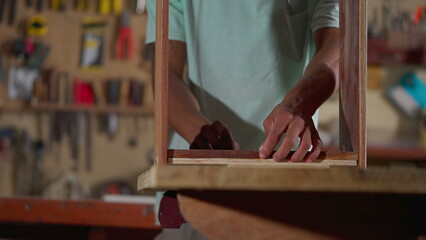 Apprentice in Action of Young Black Individual Building Furniture in Carpentry Workshop