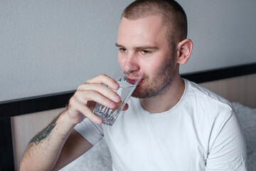 Man drinking water from a glass